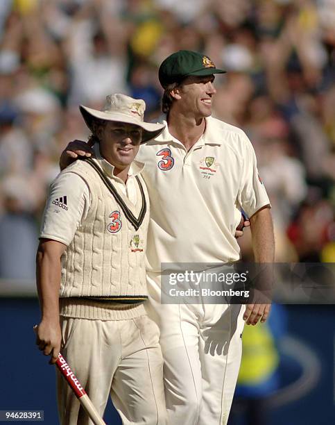 Shane Warne, left and Glenn McGrath, of Australia, wave farewell to the crowd at the Melbourne Cricket Ground, as he leaves the field, after...