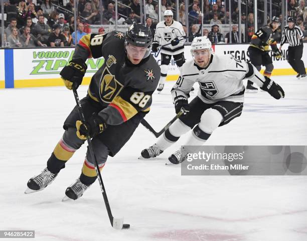 Nate Schmidt of the Vegas Golden Knights skates with the puck under pressure from Tanner Pearson of the Los Angeles Kings in the first period of Game...