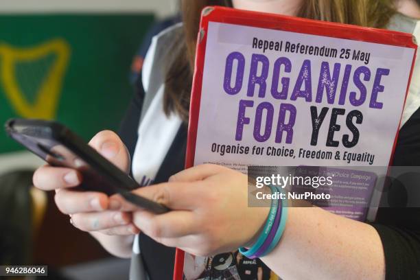 An activist holds 'Organise For Yes' leaflet during a Rally for Equality, Freedom &amp; Choice organised by ROSA - an Irish Socialist Feminist...