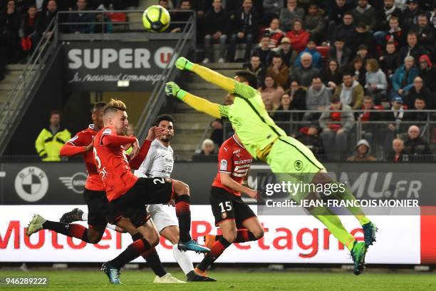 Metz's Japanese goalkeeper Eiji Kawashima dives for the ball next to Rennes' French midfielder Adrien Hunou during the French L1 football match...