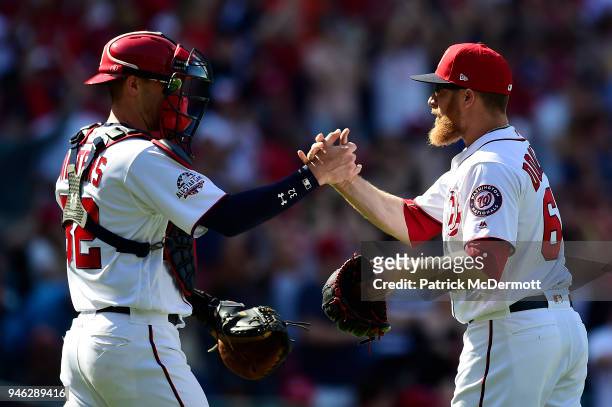 Matt Wieters and Sean Doolittle of the Washington Nationals celebrate after the Nationals defeated the Colorado Rockies 6-2 at Nationals Park on...
