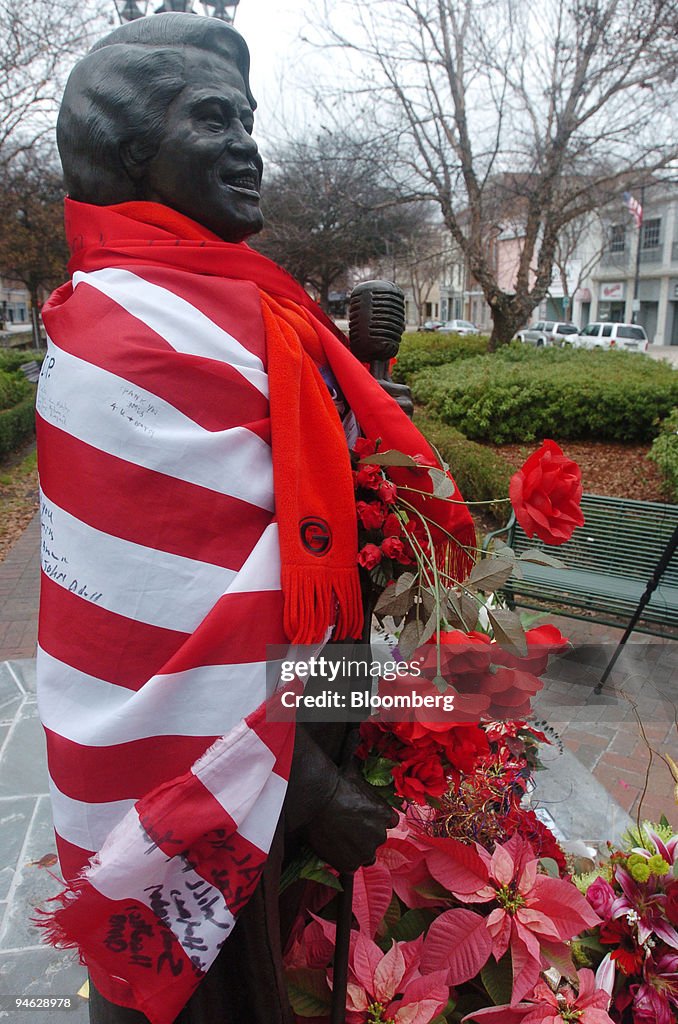 A statue of James Brown is draped with an American flag and