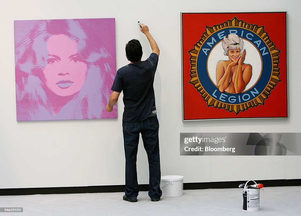 A carpenter paints the wall between Andy Warhol's ''Brigitte