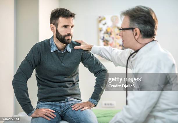 worried mid-adult visiting a doctor. - patient bad news stock pictures, royalty-free photos & images