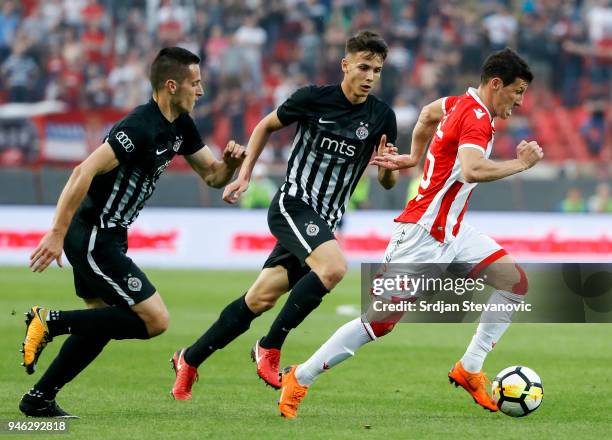 Slavoljub Srnic of Crvena Zvezda in action against Svetozar Markovic and Nemanja Miletic of Partizan during the Serbian Super League Play Off match...