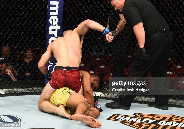 Yushin Okami of Japan punches Dhiego Lima of Brazil in their welterweight fight during the UFC Fight Night event at the Gila Rivera Arena on April...