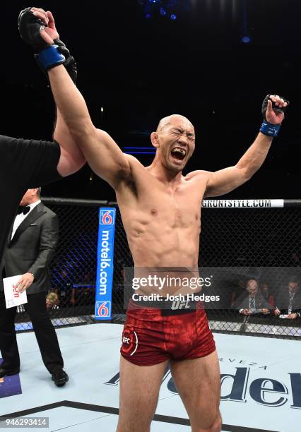 Yushin Okami of Japan celebrates his victory over Dhiego Lima of Brazil in their welterweight fight during the UFC Fight Night event at the Gila...