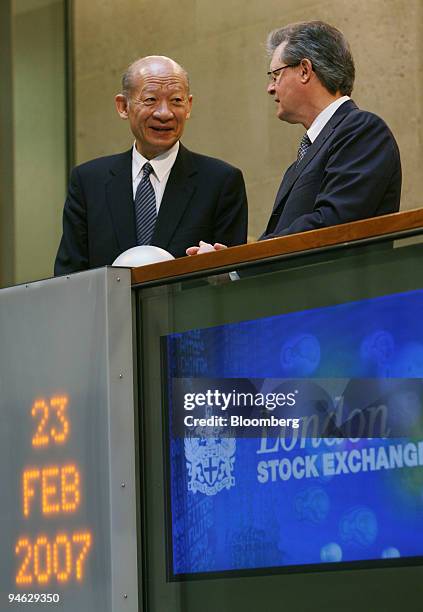 Taizo Nishimuro, president and chief executive officer of the Tokyo Stock Exchange, Inc., talks with Chris Gibson-Smith, chairman of the London Stock...