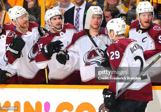 Colin Wilson, Alexander Kerfoot, and Tyson Jost of the Colorado Avalanche congratulate teammate Nathan MacKinnon on scoring a goal against the...