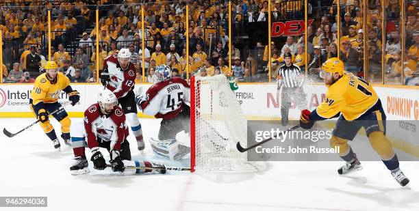 Mattias Ekholm of the Nashville Predators centers the puck against Mark Barberio and Jonathan Bernier of the Colorado Avalanche in Game Two of the...