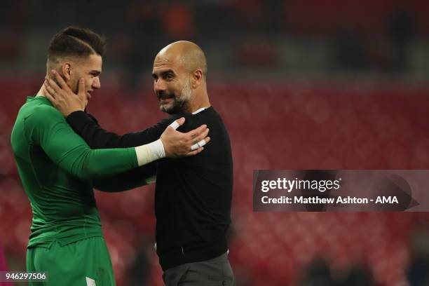 Ederson Moraes of Manchester City and Manchester City manager Pep Guardiola during the Premier League match between Tottenham Hotspur and Manchester...