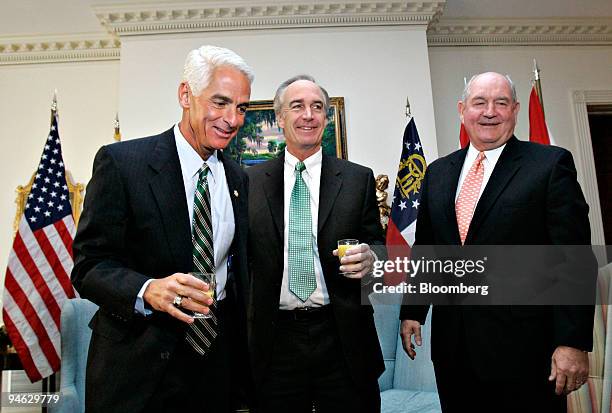 Governor Charlie Crist, a Florida Republican, left, and Governor Sonny Perdue, a Georgia Republican, right, look on as Dirk Kempthorne, U.S....