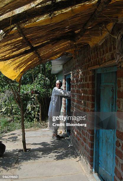 Ganga Prasad a farmer in the village of Bhaukhedi, stands outside his soybean store house in Sehore, in Madhya Pradesh, central India, on Thursday,...