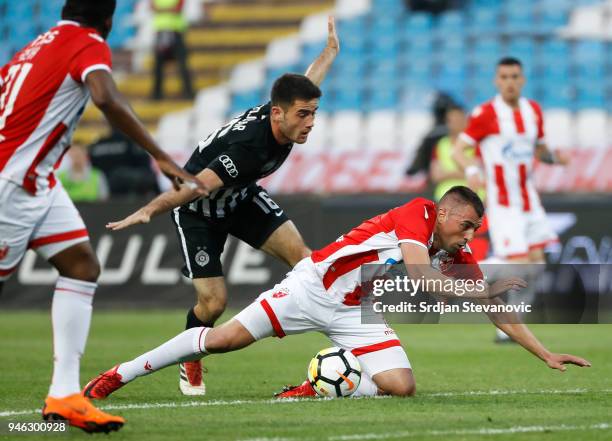 Nenad Krsticic of Crvena Zvezda is challenged by Sasa Zdjelar of Partizan during the Serbian Super League Play Off match between FK Crvena Zvezda and...