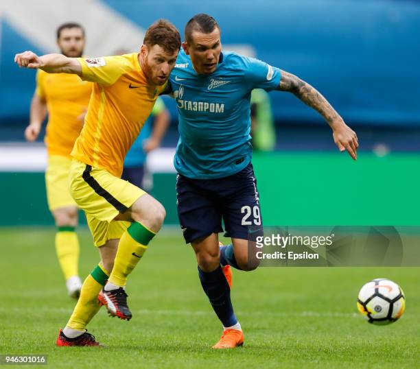 Anton Zabolotny of FC Zenit Saint Petersburg and Guram Tetrashvili of FC Anji Makhachkala vie for the ball during the Russian Football League match...