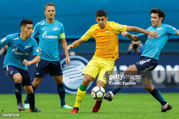 Matias Kranevitter , Domenico Criscito and Yuri Zhirkov of FC Zenit Saint Petersburg vie for the ball with Juan Lescano of FC Anji Makhachkala during...