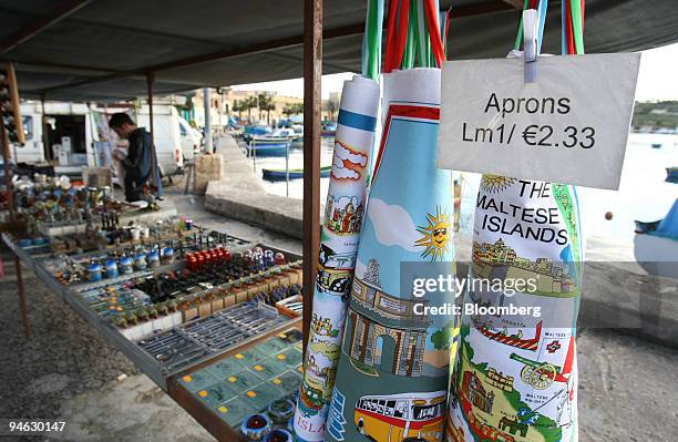 Prices for souvenir aprons are displayed in lira and euro at a market in Marsaxlokk, Malta, on Wednesday, Dec. 19, 2007. The Maltese Island is...