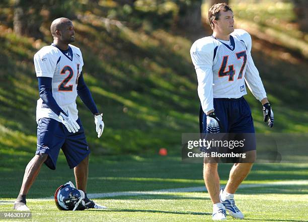 Champ Bailey, No. 24, cornerback for the Denver Broncos, and John Lynch, No. 47, safety for the Denver Broncos, stetch during practice at the Denver...