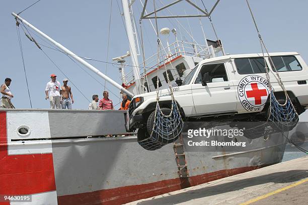 Workers unload a jeep from a International Committee of the Red Cross ship in Tyre, Lebanon, Saturday, August 12, 2006. The shipment of 200 tons of...