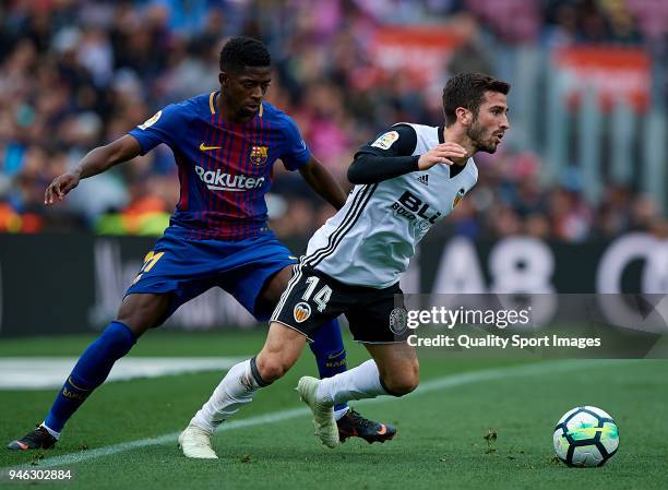 Ousmane Dembele of Barcelona competes for the ball with Jose Luis Gaya of Valencia during the La Liga match between Barcelona and Valencia at Camp...