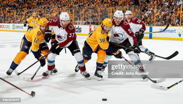 Ryan Hartman and Mike Fisher of the Nashville Predators battle for the puck against Gabriel Bourque and J.T. Compher of the Colorado Avalanche in...