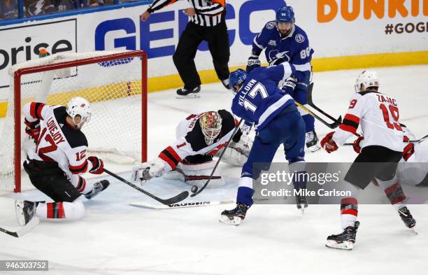 Alex Killorn of the Tampa Bay Lightning shoots the puck for a goal against Ben Lovejoy and goalie Keith Kinkaid of the New Jersey Devils in Game Two...