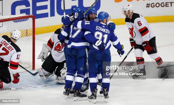 Alex Killorn of the Tampa Bay Lightning celebrates with teammates after a goal against Ben Lovejoy and goalie Keith Kinkaid of the New Jersey Devils...