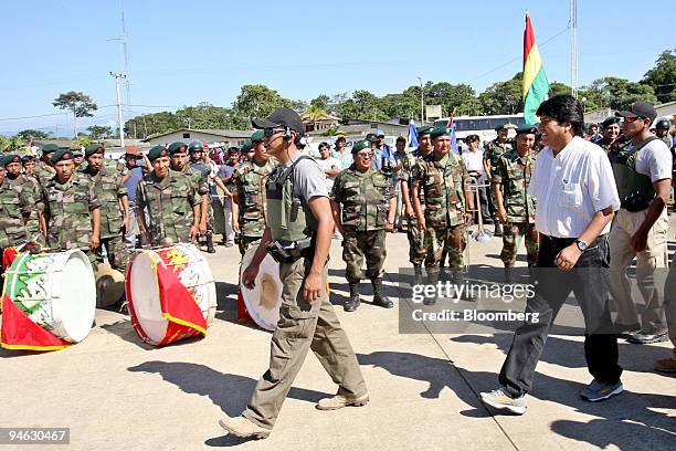 Bolivian President Evo Morales, at right in the white shirt, reviews soldiers in the Chapare region of Bolivia, where Morales became well known as a...