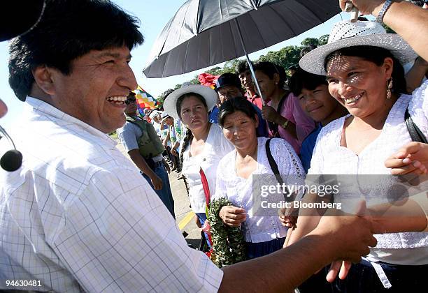 Bolivian President Evo Morales, left, jokes with supporters in his home region of Chapare, where Morales became well known as a coca grower and...