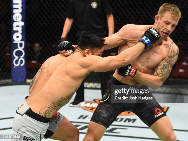 Brad Tavares punches Krzysztof Jotko of Poland in their middleweight fight during the UFC Fight Night event at the Gila Rivera Arena on April 14,...