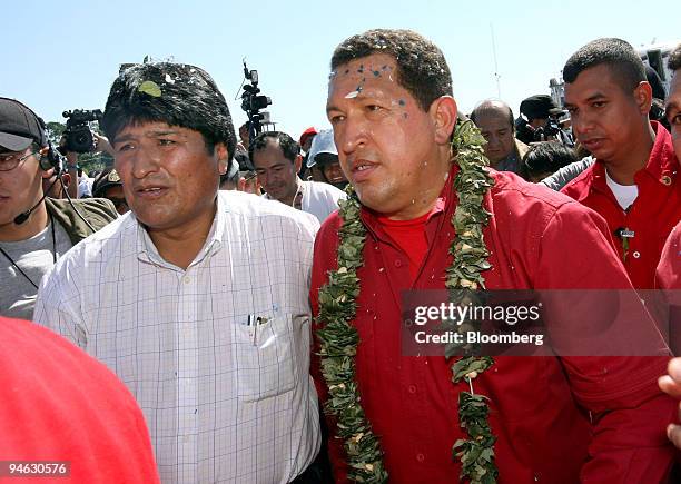 Venezuelan President Hugo Chavez, right, wearing a wreath of coca leaves, visits President Evo Morales in the Chapare region of Bolivia, where...