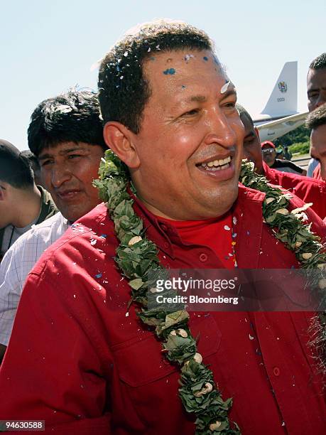 Venezuelan President Hugo Chavez, right, wearing a wreath of coca leaves, visits President Evo Morales, left background, in the Chapare region of...