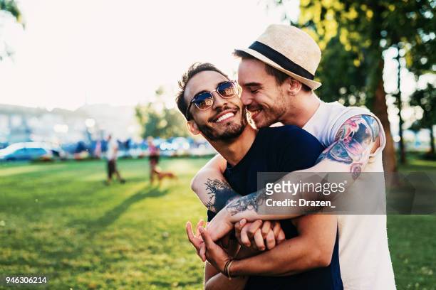 lgbt milestone and life event - gay kiss stock pictures, royalty-free photos & images