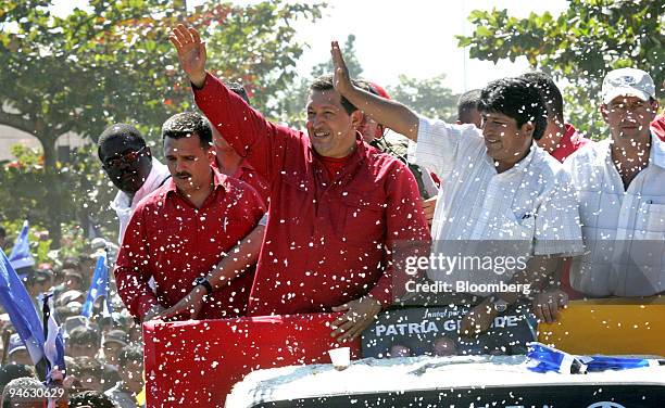 Venezuelan President Hugo Chavez, left, and Bolivian President Evo Morales, wave form their motorcade during a visit to Chapare region of Bolivia,...