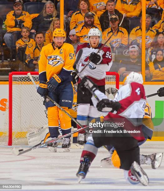 Tyson Barrie of the Colorado Avalanche takes a shot toward teammate Gabriel Landeskog and Roman Josi of the Nashville Predators during the third...