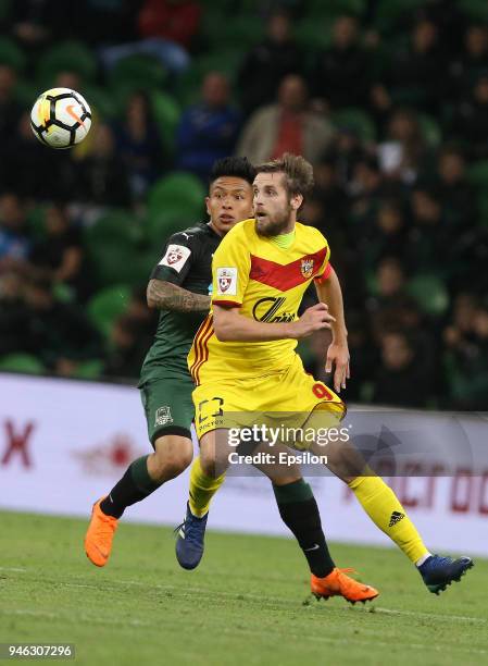 Cristian Ramirez of FC Krasnodar vies for the ball with Kirill Kombarov of FC Arsenal Tula during the Russian Premier League match between FC...