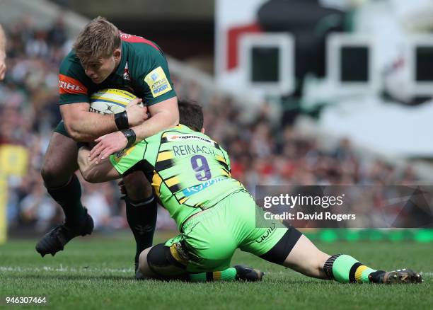 Tom Youngs of Leicester is tackled by Cobus Reinach during the Aviva Premiership match between Leicester Tigers and Northampton Saints at Welford...