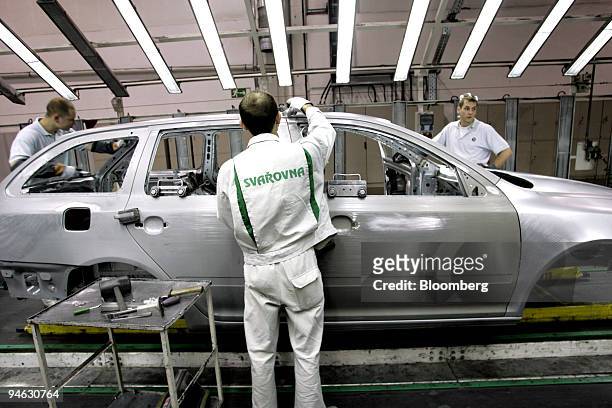 Auto workers assemble cars at Skoda Auto S.A.. In Mlada Boleslav, Czech Republic, on Tuesday, December 12, 2006.