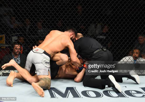 Brad Tavares punches Krzysztof Jotko of Poland in their middleweight fight during the UFC Fight Night event at the Gila Rivera Arena on April 14,...