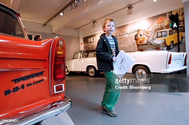 Young visitor passes the one millionth Trabant automobile produced, a 601 Deluxe model made in 1973, left, on display at the August Horch automotive...