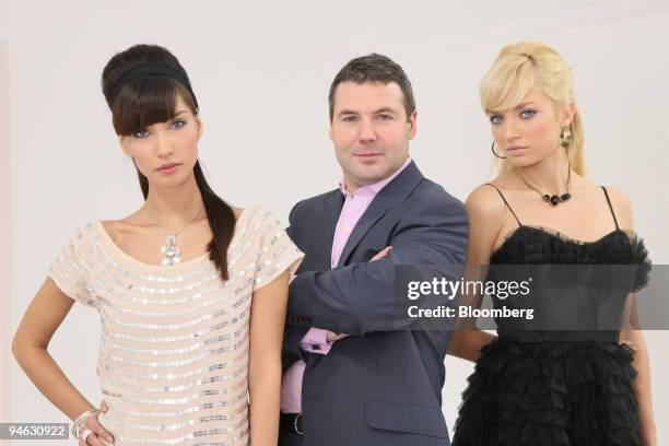 Nick Robertson, chief executive officer of internet fashion retailer Asos Plc., poses with models Mariel Booth and Elodie Bonis in London, U.K., on...