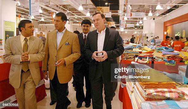 Wal-Mart's Vice Chairman Michael Duke, right, takes a tour of the Inorbit Mall accompanied by Bharti Group Joint Managing Director Rajan Mittal, far...