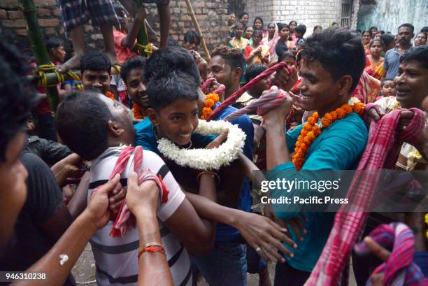 Devotees catch the devotees who perform holy jump from pole during the Charak Puja festival.Bengali observes Charak Puja on the last day of Bengali...