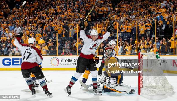 Mikko Rantanen and Tyson Jost of the Colorado Avalanche celebrate a late goal against Pekka Rinne of the Nashville Predators in Game Two of the...