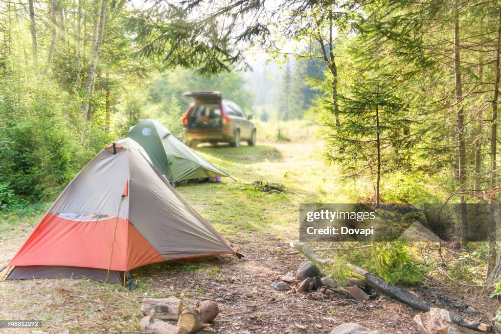 Cozy camping with tents and a car