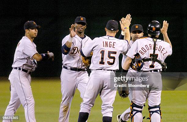 Team members of the Detroit Tigers celebrate their win against the Oakland A's during the fourth inning of the second game of the National League...