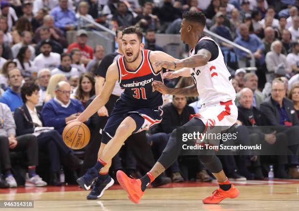 Tomas Satoransky of the Washington Wizards makes a move towards the basket as he is guarded by Delon Wright of the Toronto Raptors in the first...