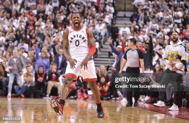 Miles of the Toronto Raptors celebrates after making a three-pointer as rap artist Drake celebrates on the sideline against the Washington Wizards in...