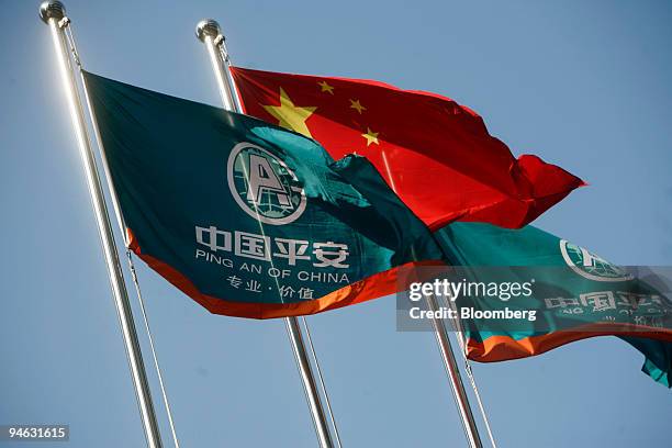 Ping An Insurance Co. Company flags fly along side the Chinese national flag at the company's headquarters in Shenzhen, China, on Monday, Dec. 10,...