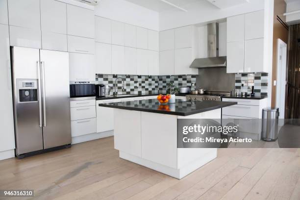 interior of modern kitchen in loft apartment - kitchen fridge stock-fotos und bilder